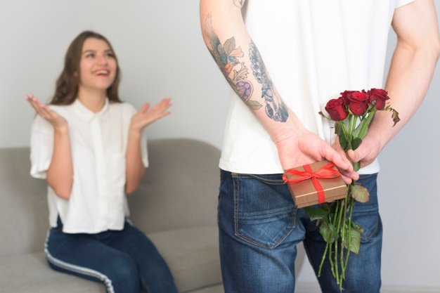 муж дарит жене цветы и подарок 